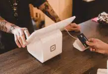 person holding white POS machine