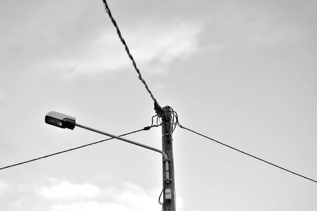 grayscale photo of electric post