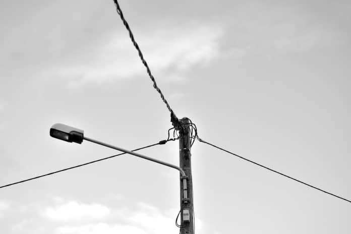 grayscale photo of electric post