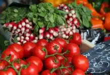 bunch of red tomatoes on top of black surface