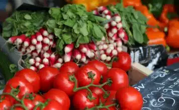 bunch of red tomatoes on top of black surface