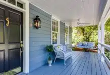 a porch with two chairs and a table on it